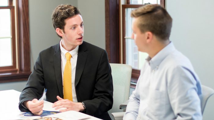 Two students talking with each other in small room