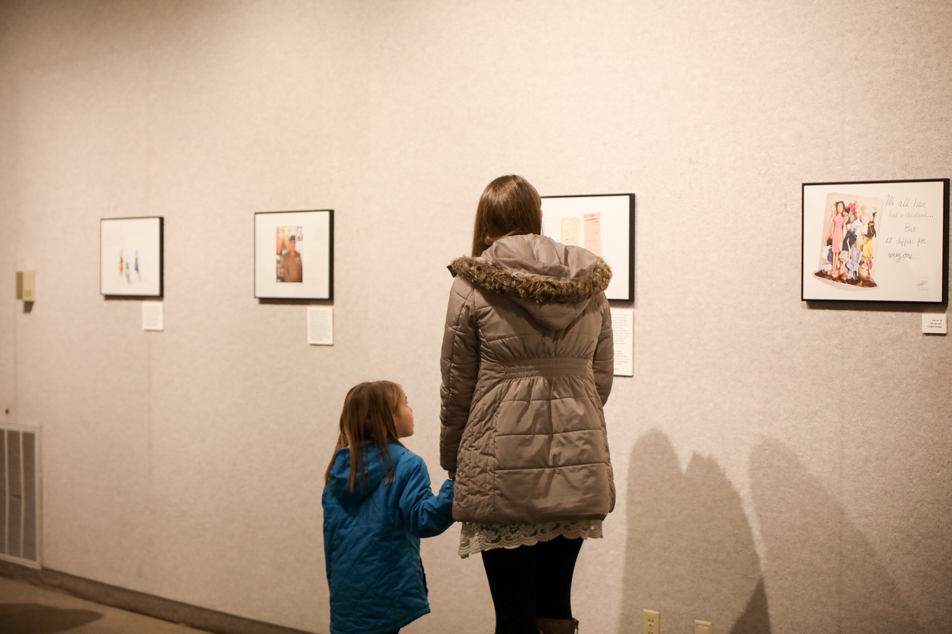 Visitors view pieces from the "What We Carried" exhibition