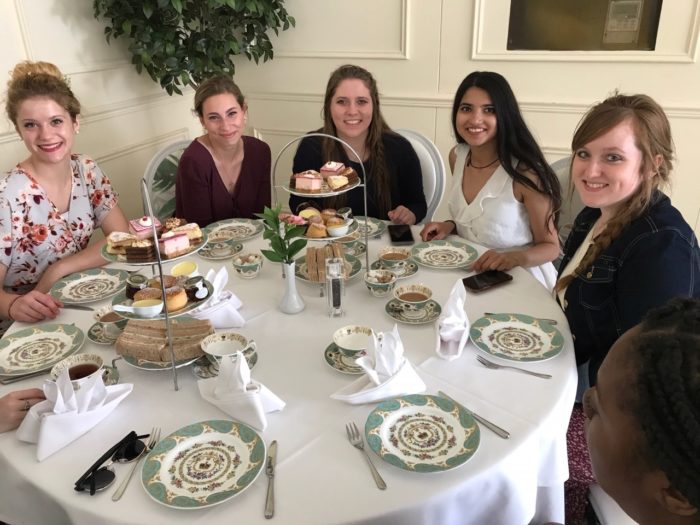 Students at table for high tea at Kensington