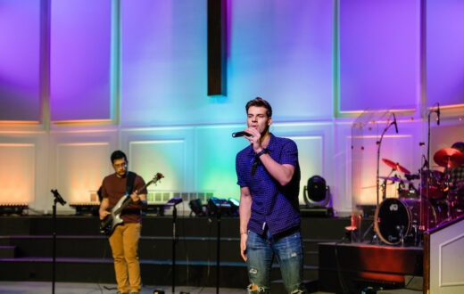 College student singing on stage