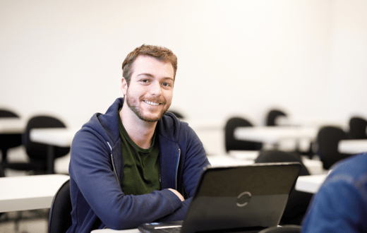 Smiling student with laptop computer