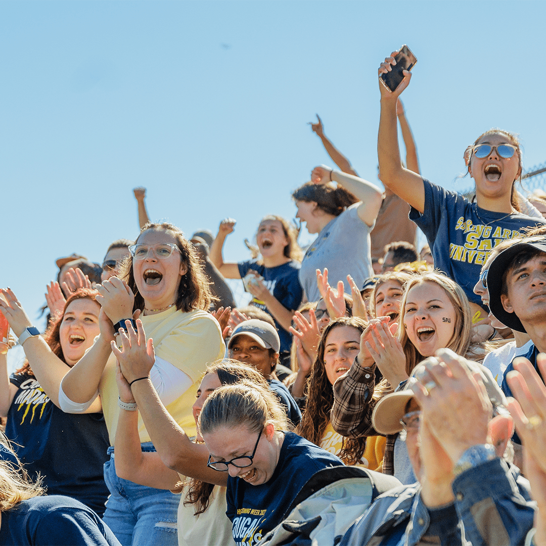 students celebrating a homecoming soccer game