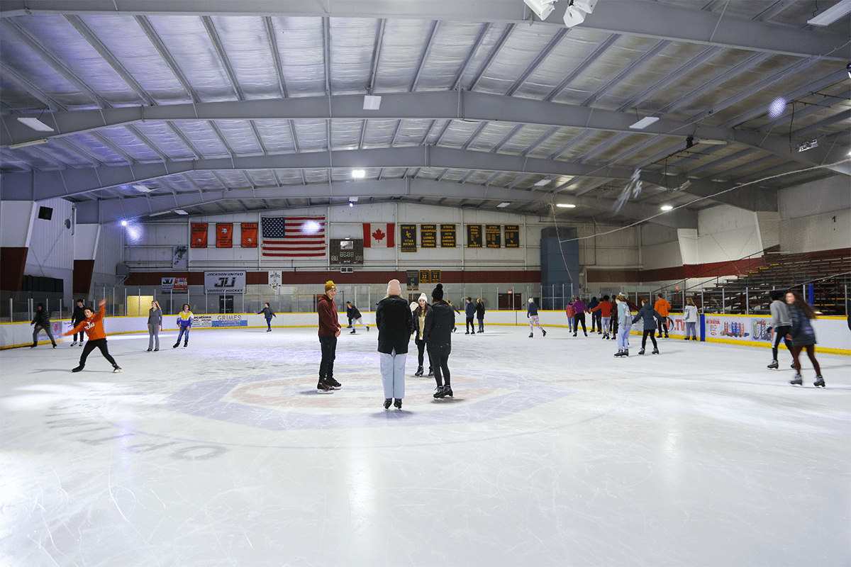 Ice rink where people are skating and having fun!