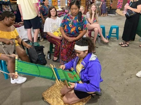 Student in Guatemala working with textiles.